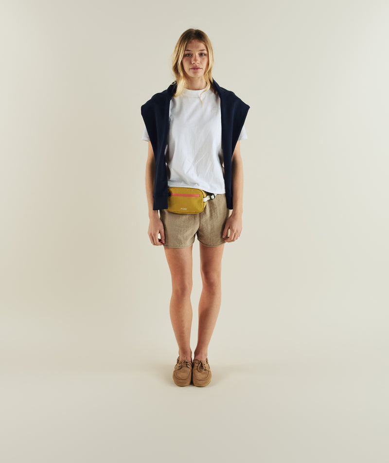 Woman wearing FOM ladies regular tee in white